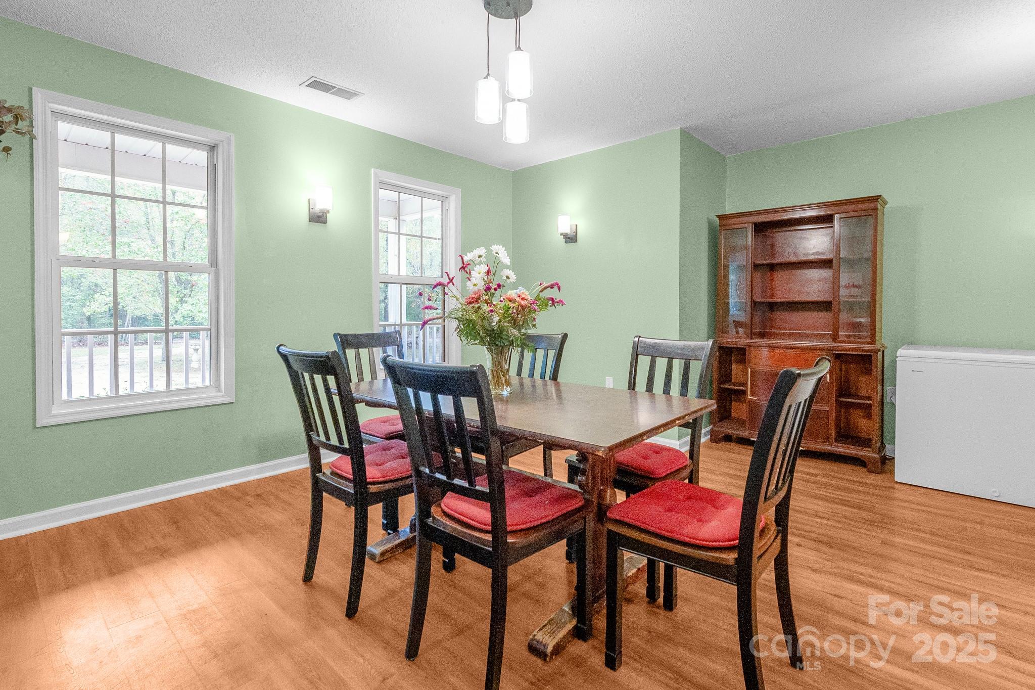 443 State Rd S-28-101 Elgin, SC 29045 - Photo 3 of 45 a view of a dining room with furniture window and wooden floor