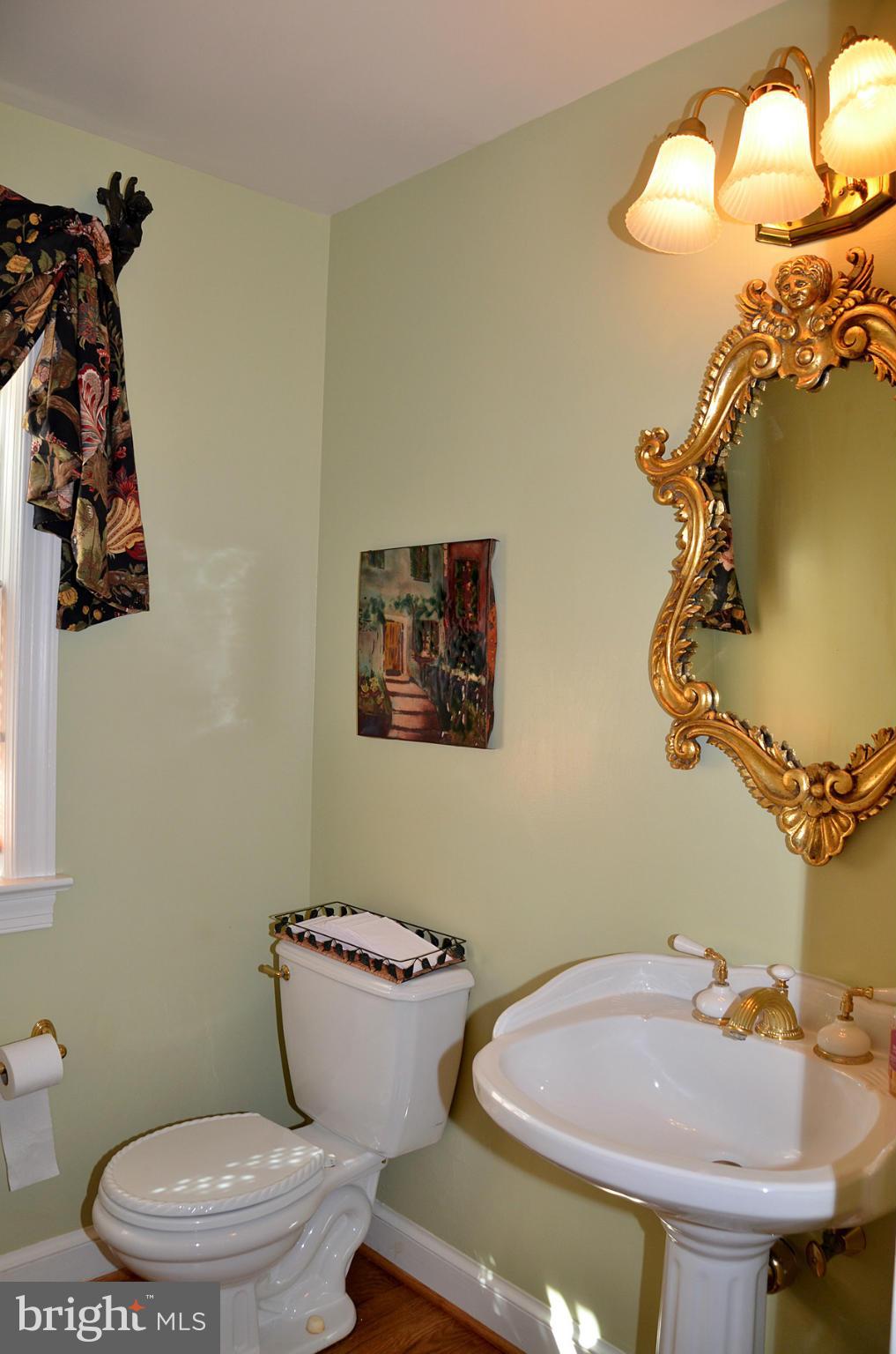 7011 Holyrood Drive McLean, VA 22101 - Photo 14 of 30 a bathroom with a toilet a sink and mirror