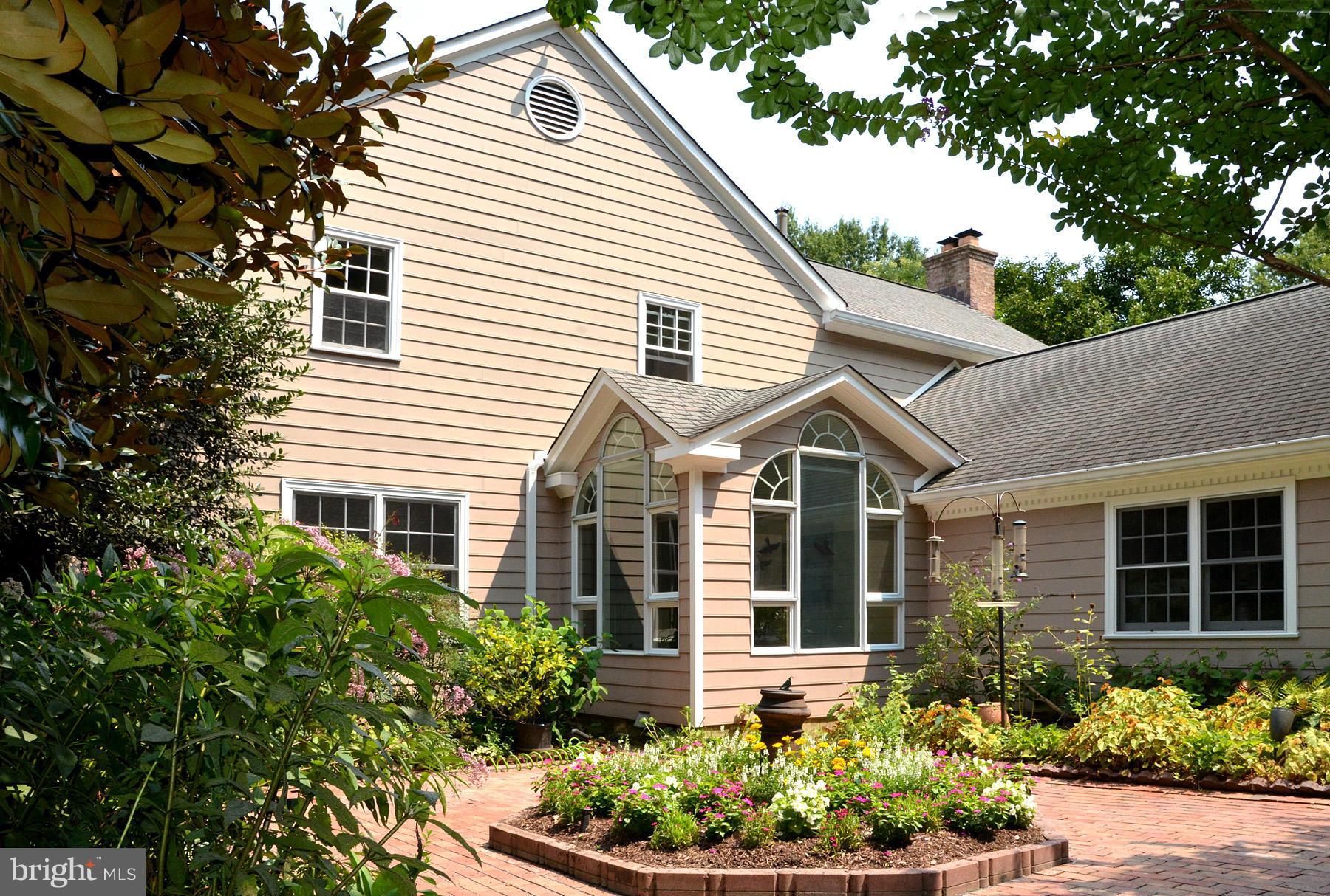 7011 Holyrood Drive McLean, VA 22101 - Photo 3 of 30 a front view of a house with a yard and potted plants
