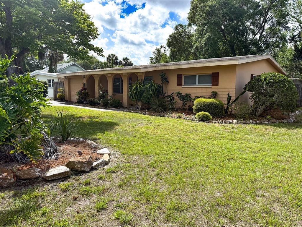 5406 Dartmouth Road New Port Richey, FL 34652 - Photo 1 of 1 a view of a house with a yard and potted plants
