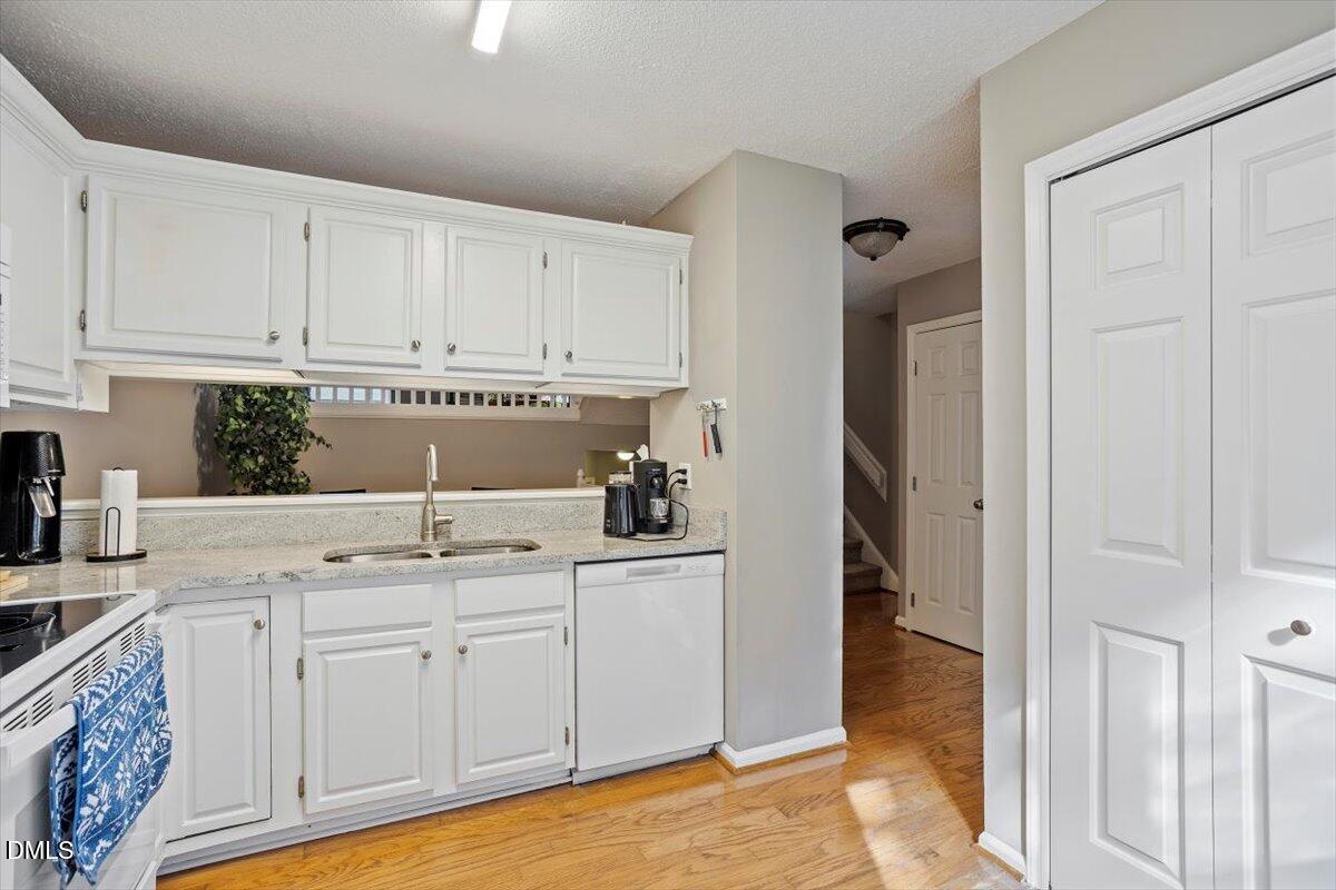 100 Hunting Chase, Unit 1D Cary, NC 27513 - Photo 12 of 29 a kitchen with white cabinets and sink