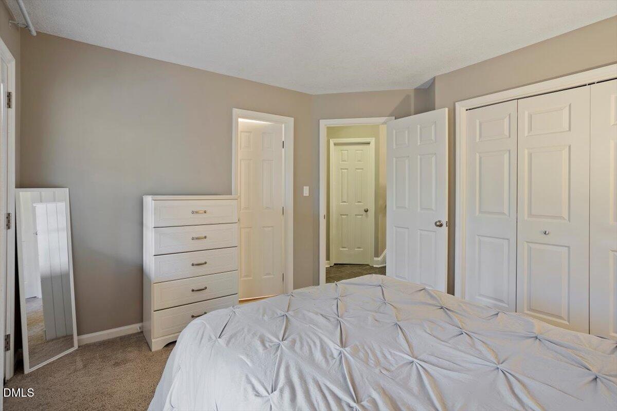 100 Hunting Chase, Unit 1D Cary, NC 27513 - Photo 17 of 29 a bedroom with a bed and a closet
