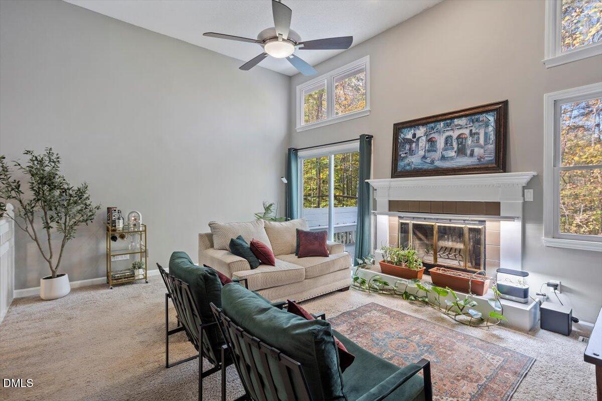 100 Hunting Chase, Unit 1D Cary, NC 27513 - Photo 20 of 29 a living room with furniture a fireplace and a flat screen tv