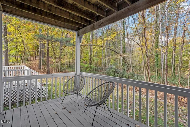 a view of a porch with wooden floor and furniture
