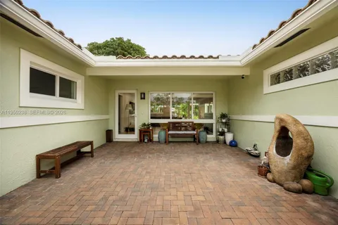 a view of a patio with table and chairs