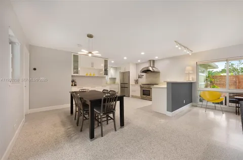 a kitchen with a table and chairs in it