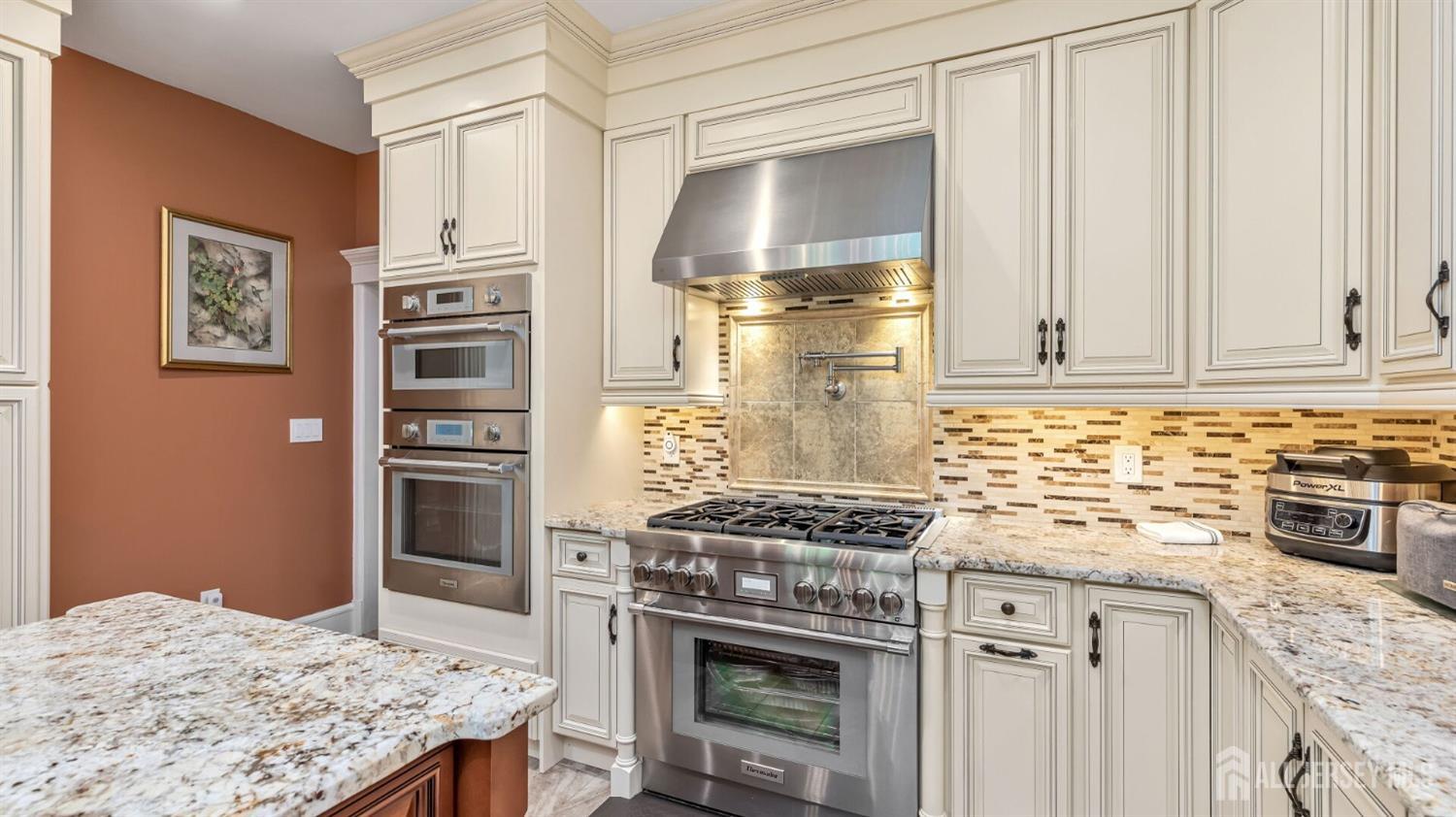 1275 Denmark Road Plainfield, NJ 07062 - Photo 15 of 87 a kitchen with stainless steel appliances a stove a refrigerator and a cabinets
