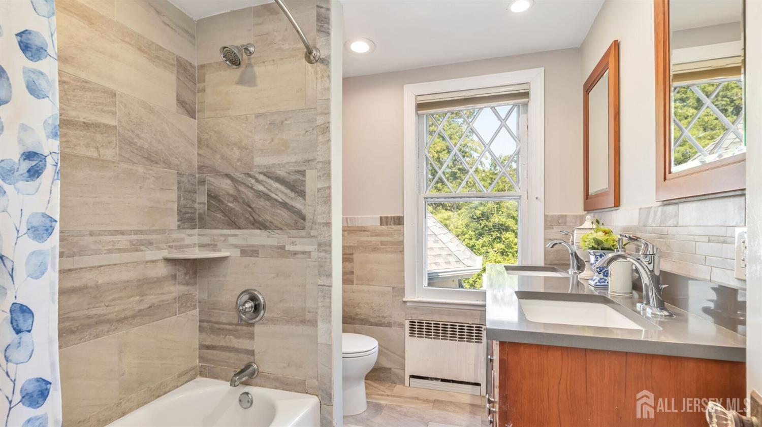 1275 Denmark Road Plainfield, NJ 07062 - Photo 41 of 87 a bathroom with a granite countertop sink a mirror and a shower