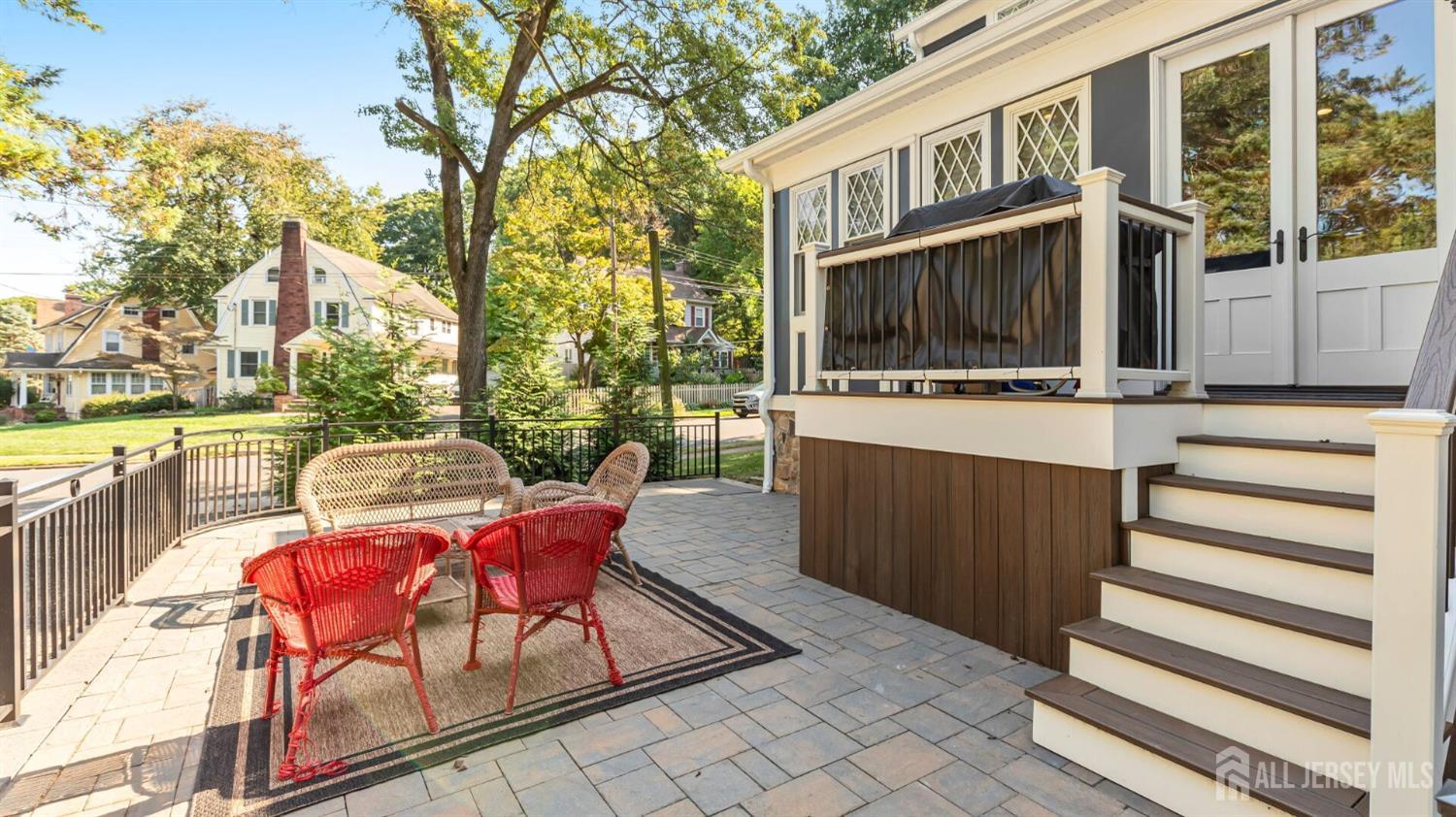 1275 Denmark Road Plainfield, NJ 07062 - Photo 85 of 87 a view of a patio with table and chairs with wooden floor and fence