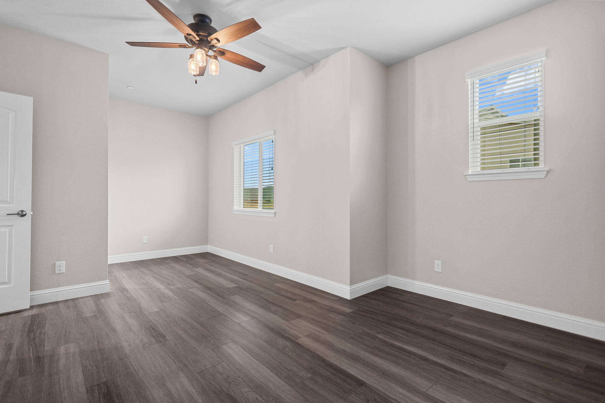 866 Congaree Lane Redding, CA 96001 - Photo 13 of 17 an empty room with wooden floor chandelier fan and windows