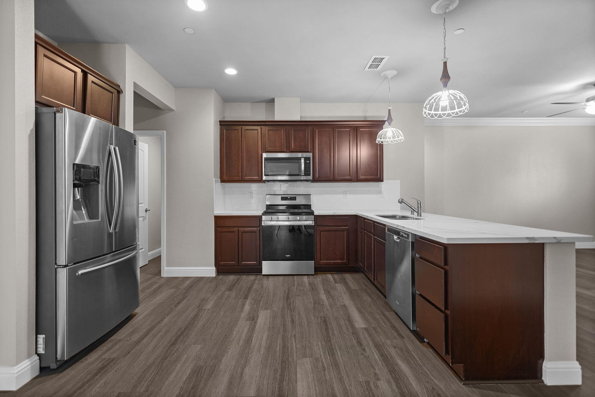 866 Congaree Lane Redding, CA 96001 - Photo 3 of 17 a kitchen with stainless steel appliances granite countertop a refrigerator a sink dishwasher a stove and a refrigerator with wooden floor