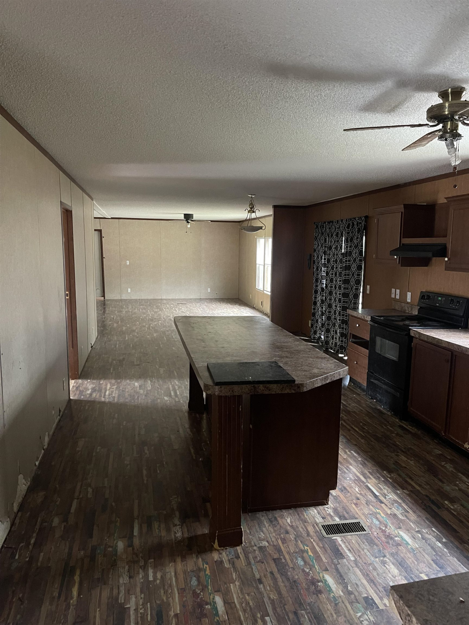 47 Wilkins Road Huron, TN 38345 - Photo 12 of 29 a kitchen with a stove and a refrigerator