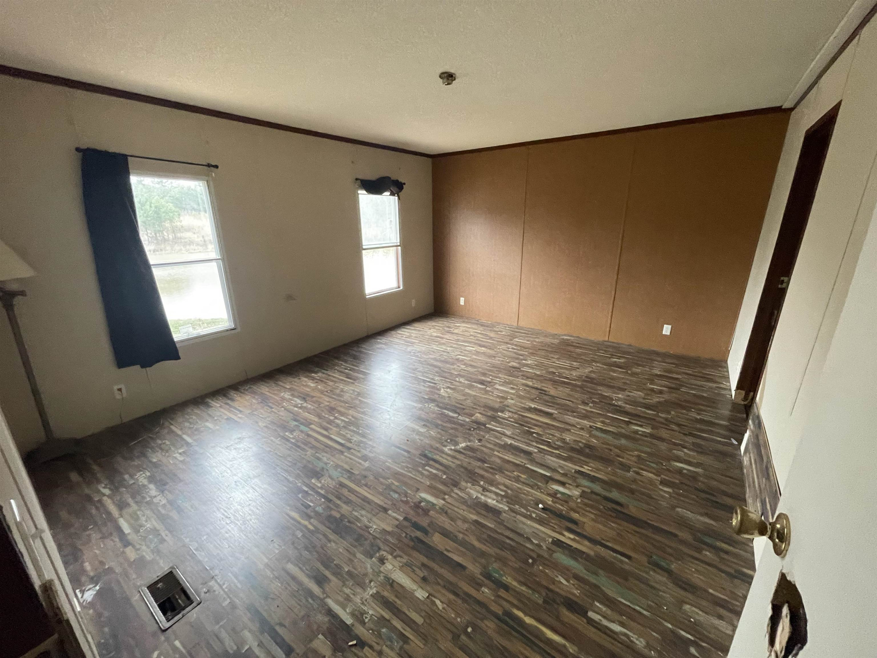 47 Wilkins Road Huron, TN 38345 - Photo 13 of 29 a view of an empty room with wooden floor and a window