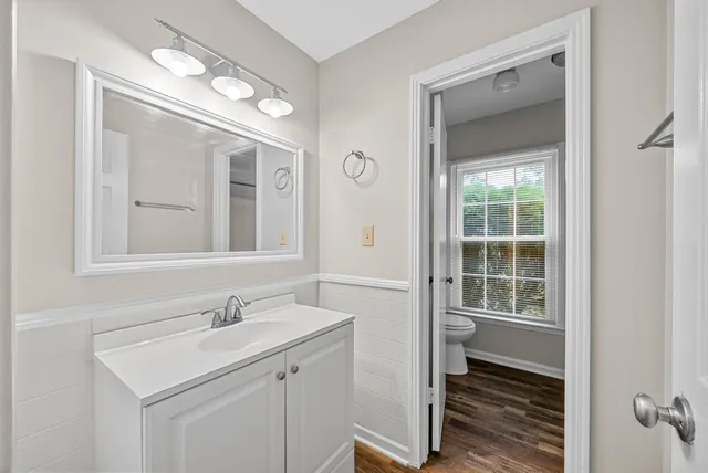 a bathroom with a sink vanity and a mirror