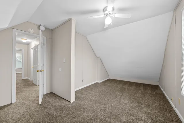 wooden floor in an empty room and a bathroom