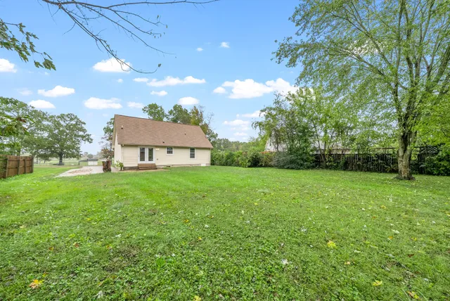 a view of a house with backyard and garden