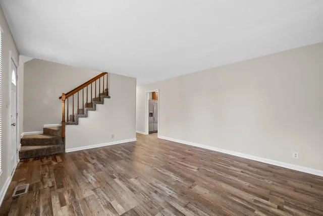 a view of main area with wooden floor and stairs