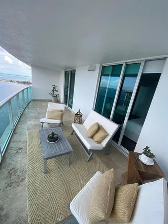 a view of a balcony with table and chairs