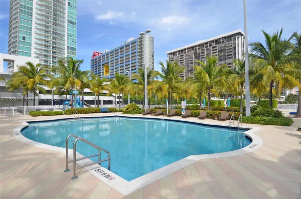 a view of swimming pool with outdoor seating and plants