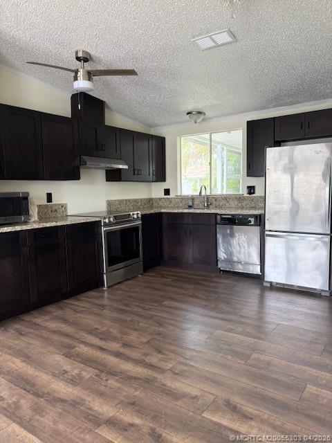 410 Southwest 134th Way Davie, FL 33325 - Photo 2 of 8 a kitchen with stainless steel appliances granite countertop a sink and cabinets