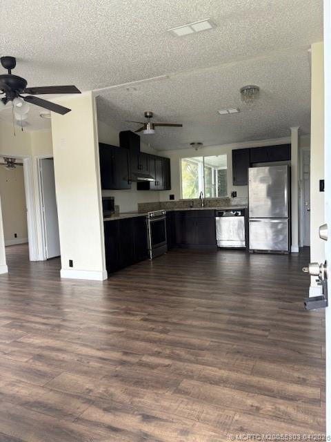 410 Southwest 134th Way Davie, FL 33325 - Photo 3 of 8 a view of a living room a kitchen island hardwood floor and a window