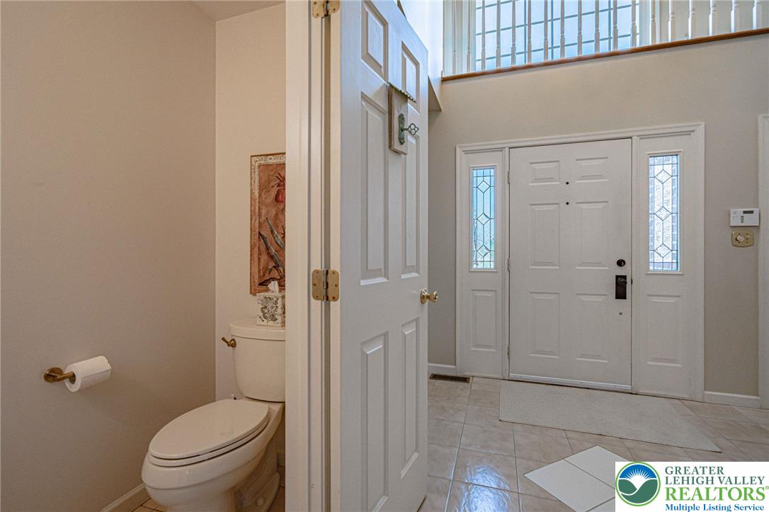 4542 Springfield Drive Coplay, PA 18037 - Photo 37 of 89 Lovely two-story foyer with a stinning arch window above the door offering abundant light and a welcoming atmosphere.