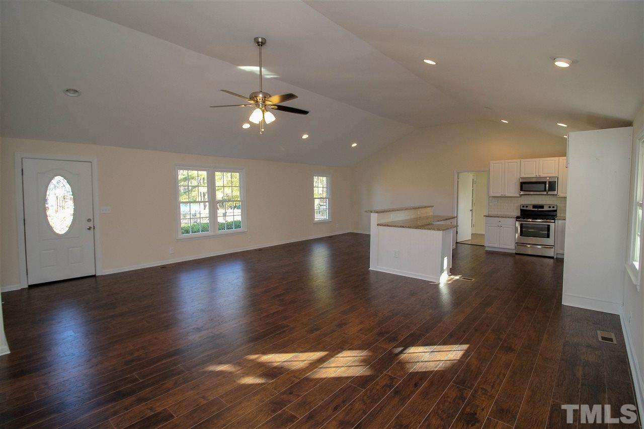 6024 Stancil Farm Road Raleigh, NC 27603 - Photo 1 of 23 an open space with kitchen view and wooden floor