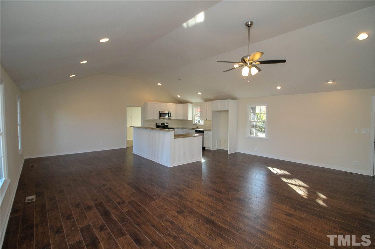 6024 Stancil Farm Road Raleigh, NC 27603 - Photo 2 of 23 a view of a kitchen with a sink a ceiling fan and wooden floor