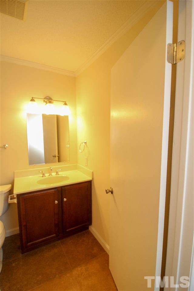 6024 Stancil Farm Road Raleigh, NC 27603 - Photo 14 of 23 a bathroom with a sink and a mirror