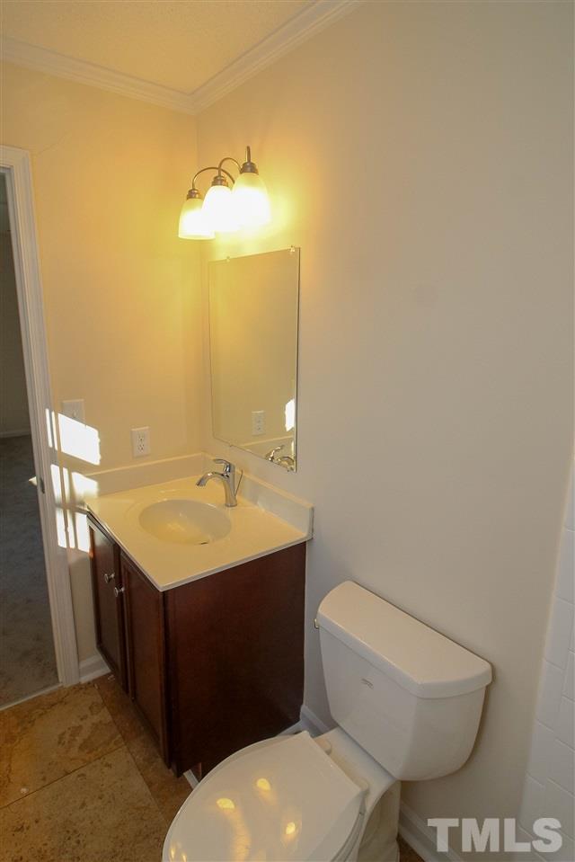 6024 Stancil Farm Road Raleigh, NC 27603 - Photo 15 of 23 a bathroom with a toilet sink and mirror