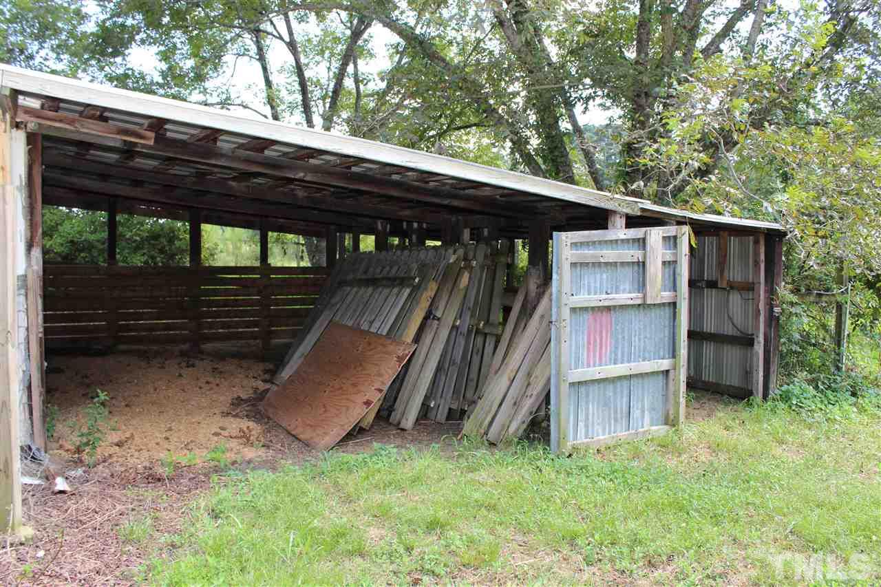 6024 Stancil Farm Road Raleigh, NC 27603 - Photo 16 of 23 a backyard of a house with wooden floor and stairs