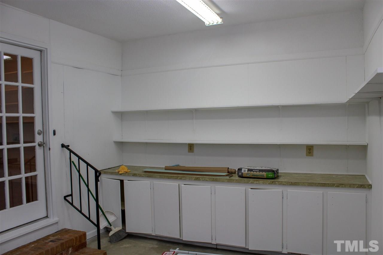 6024 Stancil Farm Road Raleigh, NC 27603 - Photo 18 of 23 a kitchen with cabinets and a wooden floors