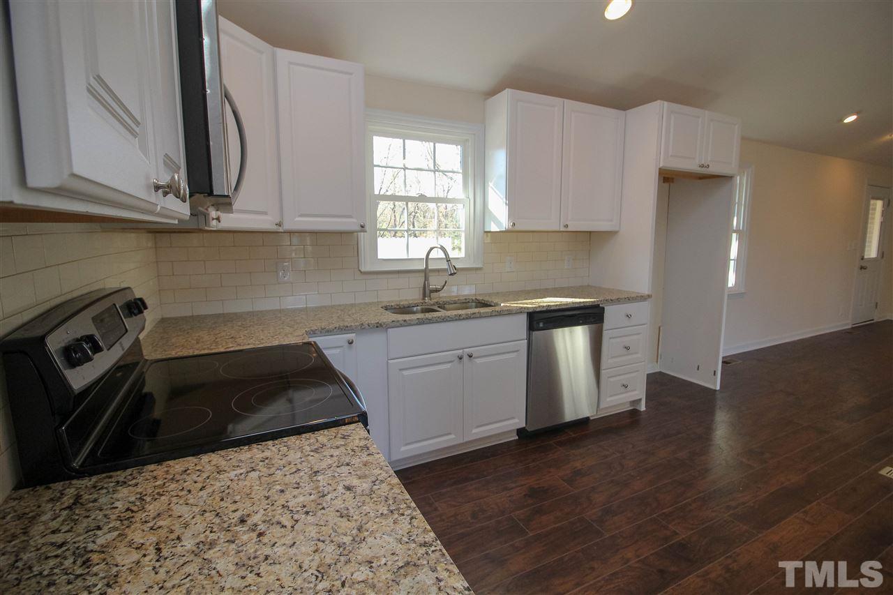 6024 Stancil Farm Road Raleigh, NC 27603 - Photo 5 of 23 a kitchen with a sink stove and cabinets