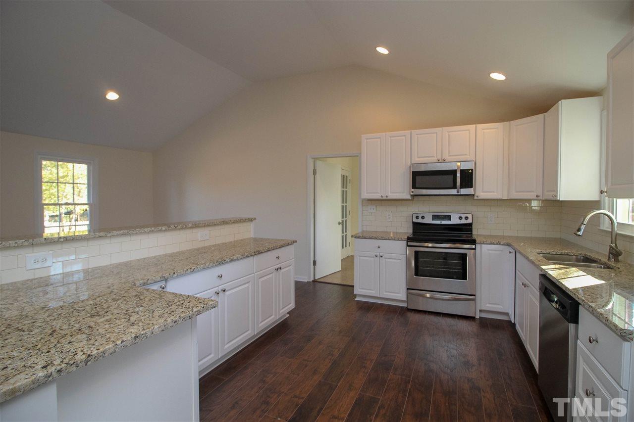 6024 Stancil Farm Road Raleigh, NC 27603 - Photo 6 of 23 a large kitchen with a stove sink and a microwave
