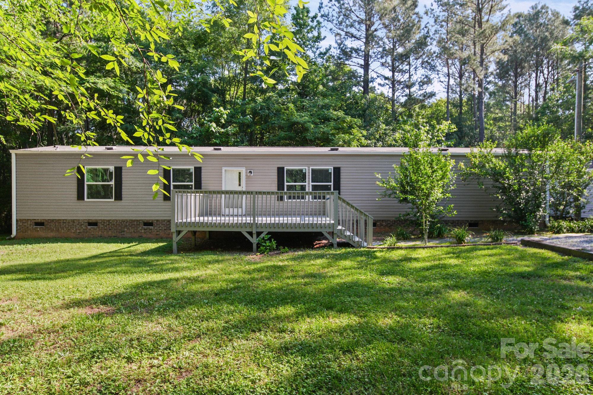 4507 White Store Road Wingate, NC 28174 - Photo 2 of 29 a view of a house with a backyard