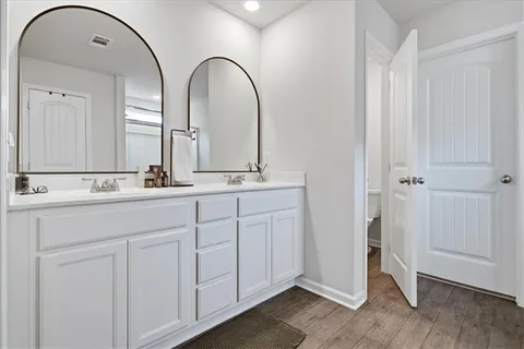 a bathroom with a double vanity sink and a mirror