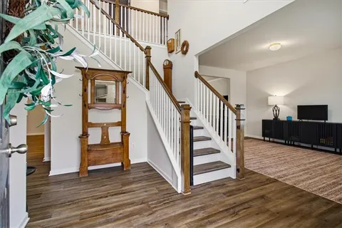 a view of entryway and hall with wooden floor