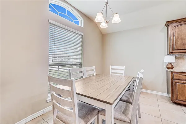a view of a dining room with furniture and chandelier