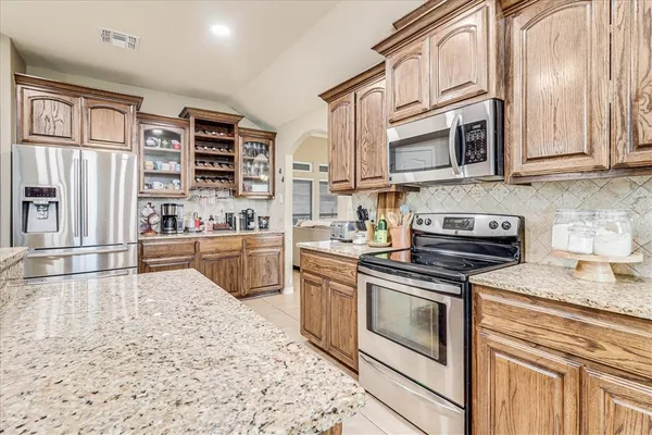 a kitchen with stainless steel appliances granite countertop a stove and a sink