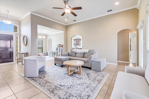 a living room with furniture and a chandelier