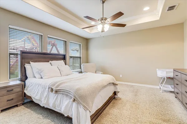 a bedroom with a large bed and a chandelier