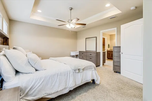 a bedroom with a bed and a ceiling fan