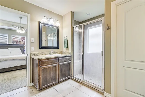 a bathroom with a granite countertop sink mirror and