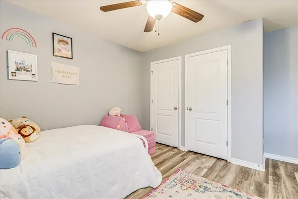 a bedroom with a bed and a painting on the wall