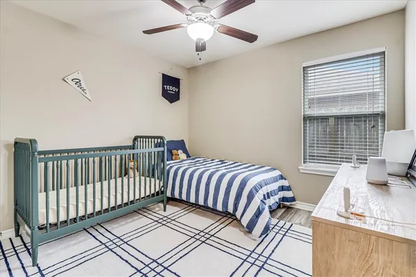 a bedroom with bed and wooden floor