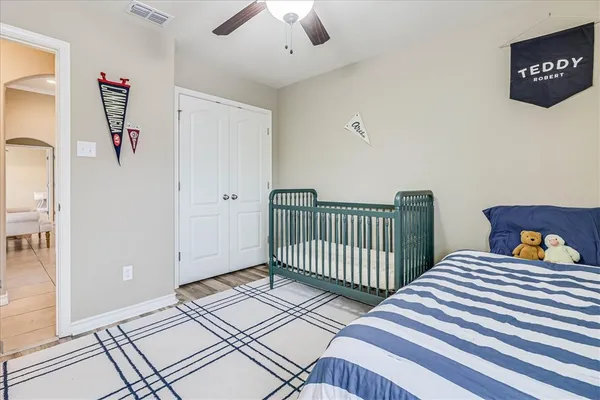 a bedroom with two beds and a chandelier