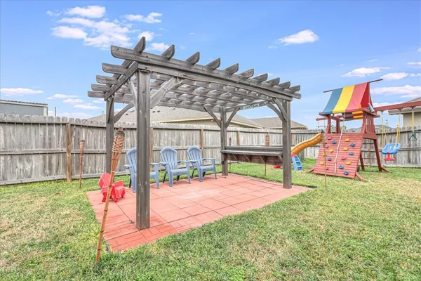 a view of a house with a yard and potted plants