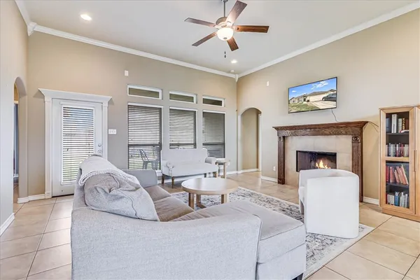 a living room with furniture a fireplace and a flat screen tv