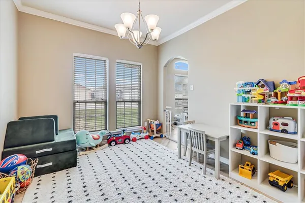 a living room with furniture toys and a window