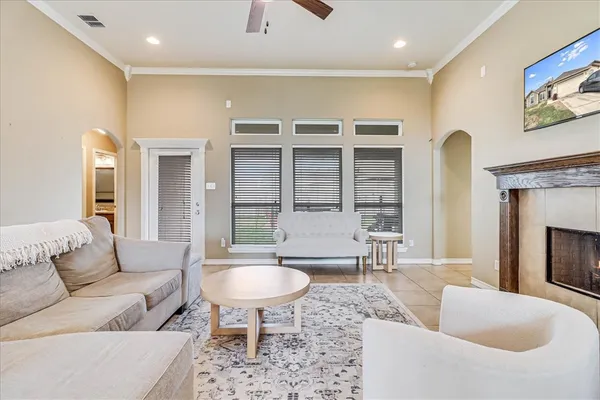 a living room with furniture a table and a fireplace